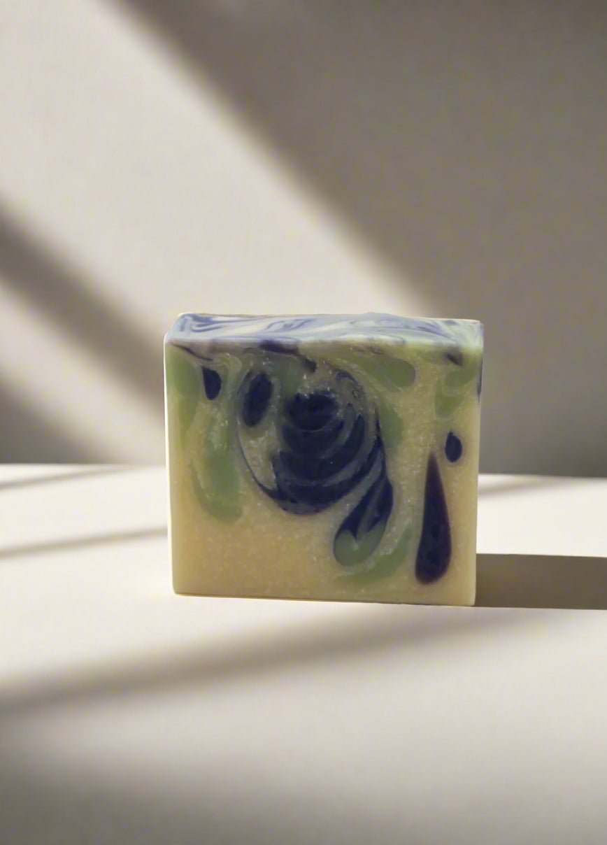 Swirl patterned soap bar on with neutral background.