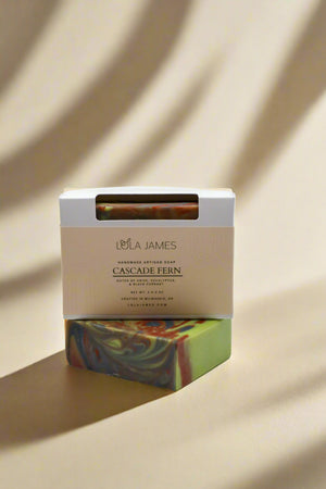 Colorful soap bar with a Lola James packaging on a neutral background