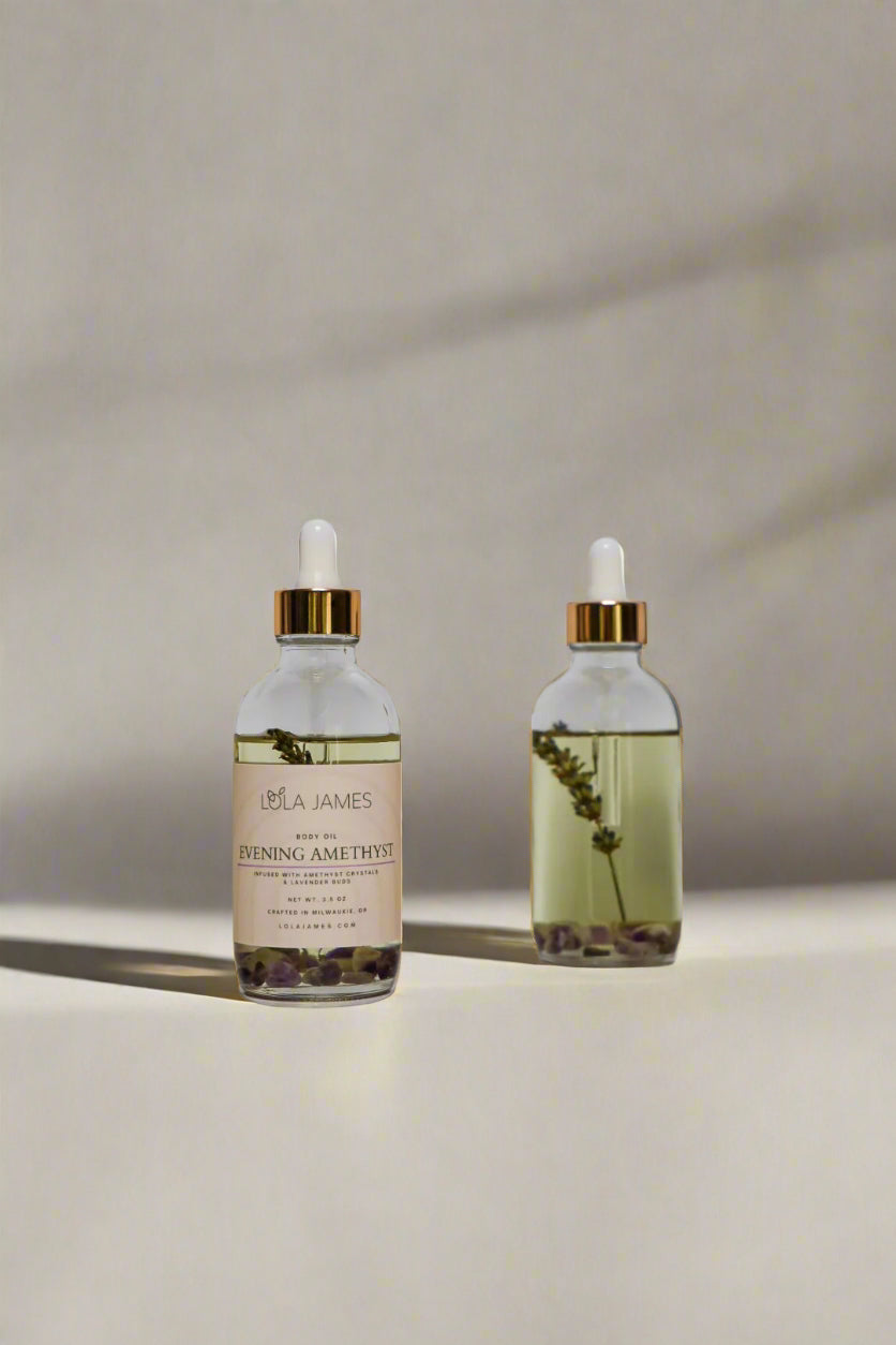 Two bottles of Lola James lavender body oil on a light gray background