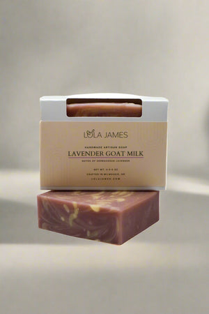 Lavender goat milk soap with packaging on a neutral background