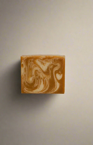 Marbled gold and white soap bar on a white background