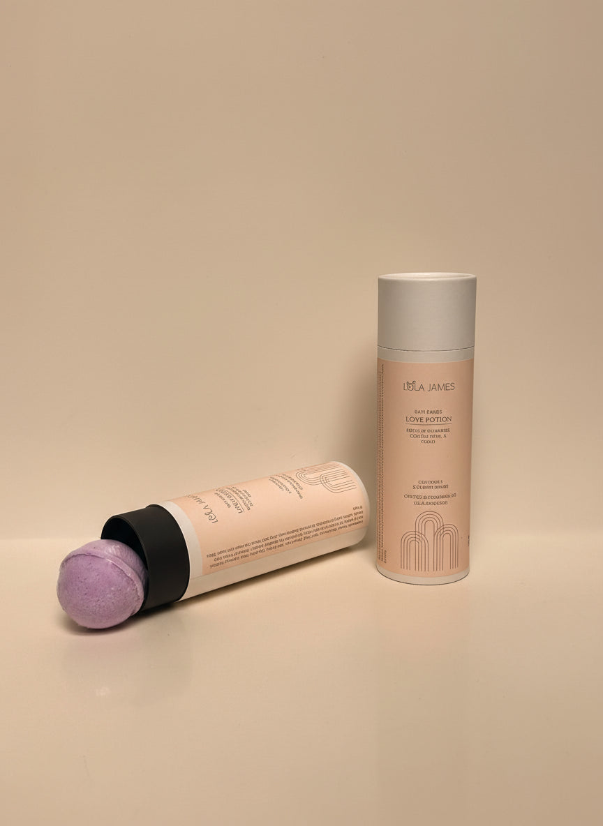 Cosmetic tube filled with purple bath bombs on a beige background.