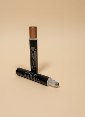 Two rollerball fragrance with 'Lola James' branding on a tan background
