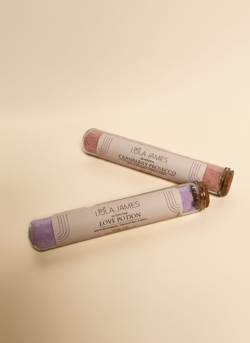 Two Lola James test tubes of Bath Potion  on a cream background