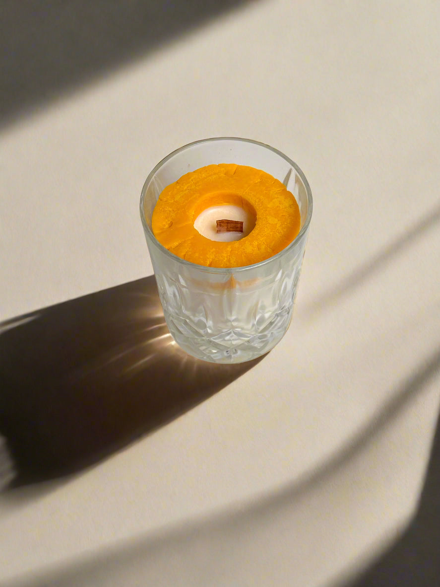 Crystal glass with a wooden wick and a pineapple ring embed.