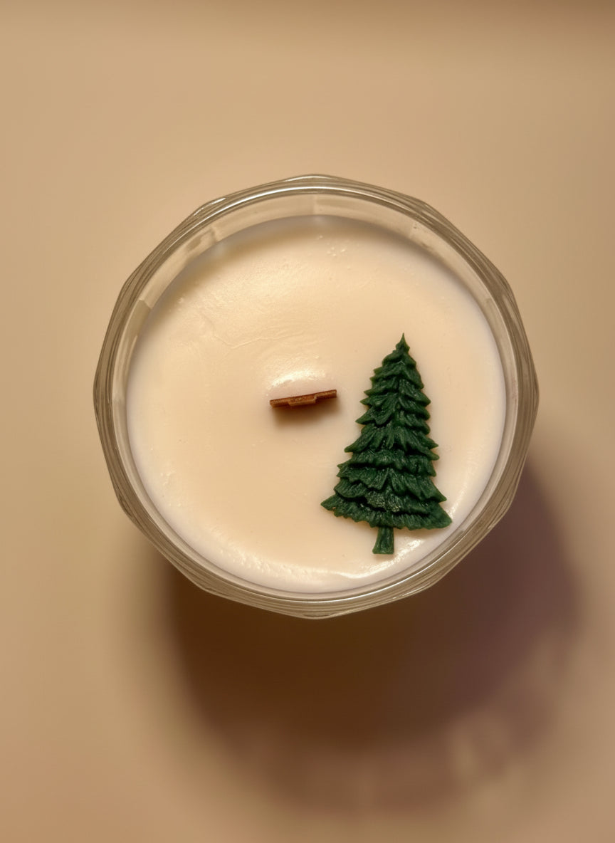 Candle with a Christmas tree decoration on a neutral background