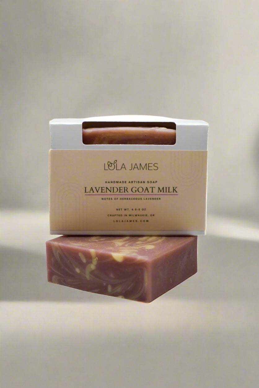 Lavender goat milk soap with packaging on a neutral background