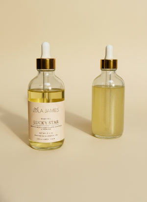 Two glass bottles with gold caps labeled 'Lucky Star' on a beige background