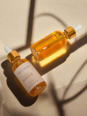 2 bottles of collagen serum with gold lids.