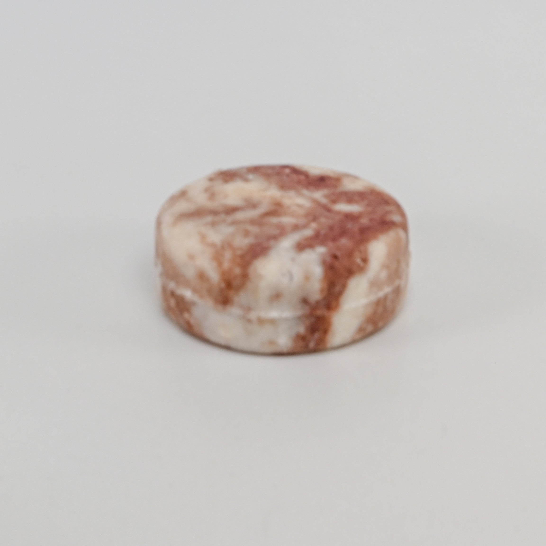 A round marble look shampoo bar