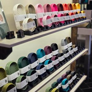 Rows of colorful travel cases on shelves.