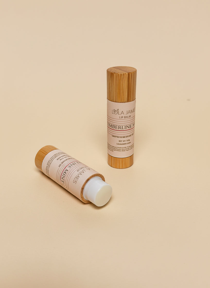 2 bamboo lip balm containers on a beige background