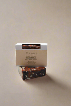 Bar of soap with a Lola James box on a neutral background