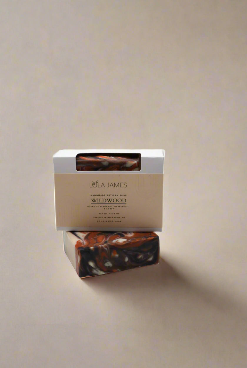 Bar of soap with a Lola James box on a neutral background